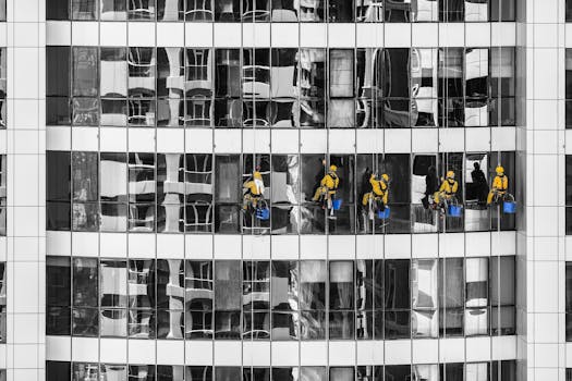 High-rise window cleaners in Dubai cleaning a skyscraper, showcasing urban architecture.
