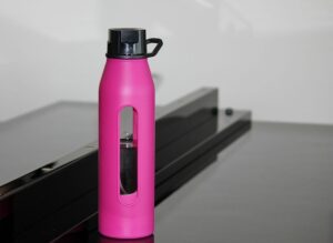water bottle, hot pink bottle, water, nature, bottle, piano, drink, pink, liquid, gray water, gray bottle, gray piano