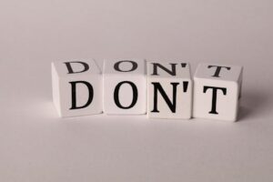 Text cubes spelling 'DON'T' on a clean white background, ideal for concepts of caution or prohibition.